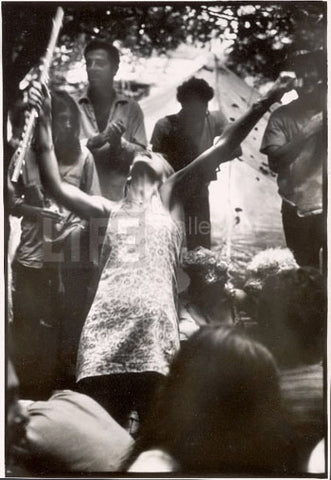Hippie Girl Playing Flute at Woodstock, 1969 by Bill Eppridge