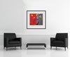Room view — Red and Grey by Regina Saura shown to scale on a gallery wall at 24 x 27 in. Not a reproduction of the work.