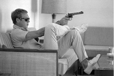Steve McQueen Aims a Pistol in his Living Room - John Dominis