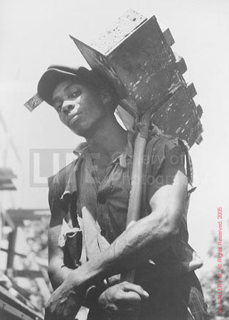 Brick Carrier at Model Community by Carl Mydans